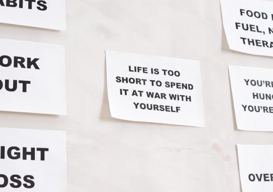 Motivational quotes on white paper promoting healthy habits and lifestyle changes.